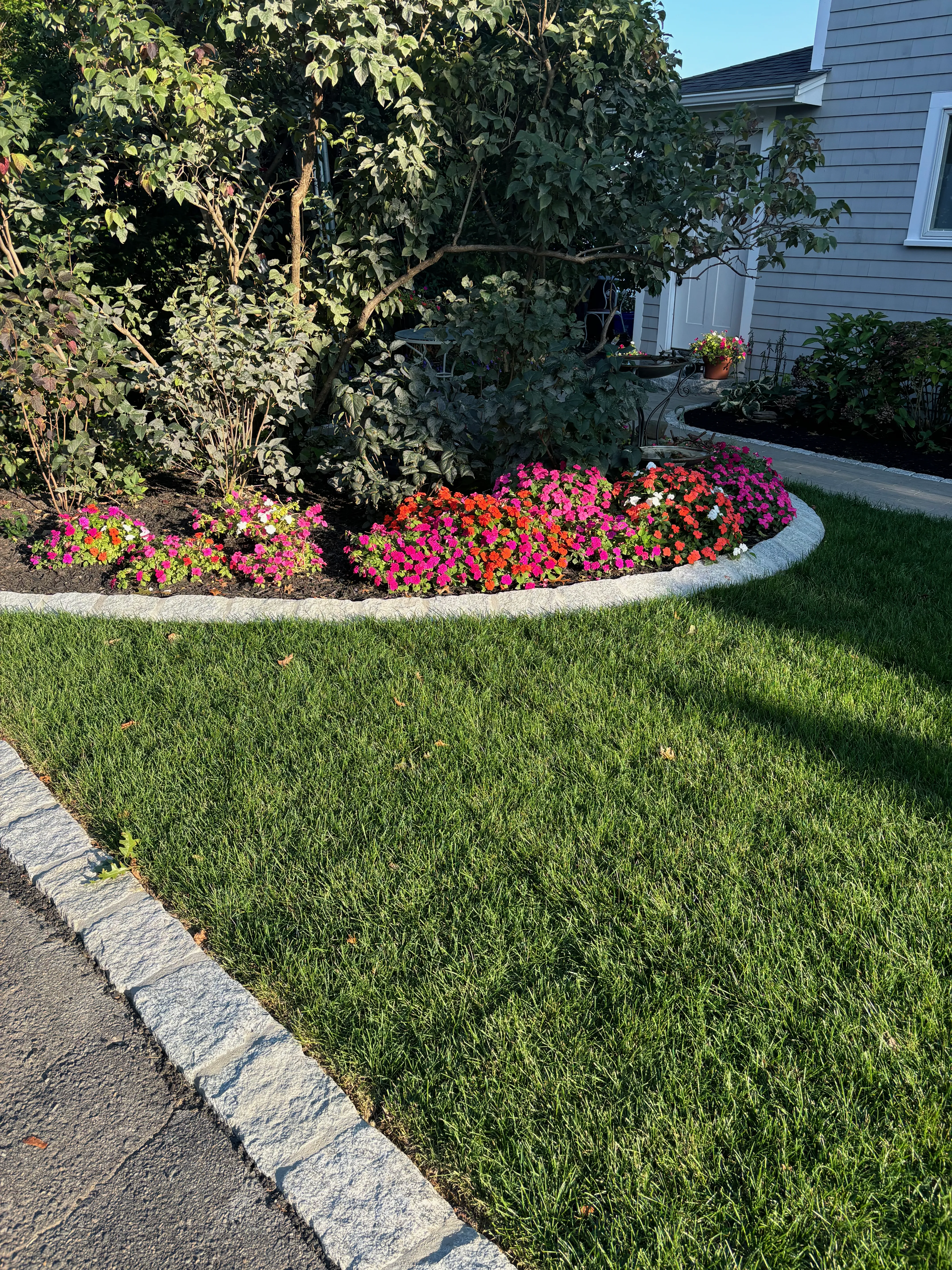 Front entry hardscape with paver walkway and edging