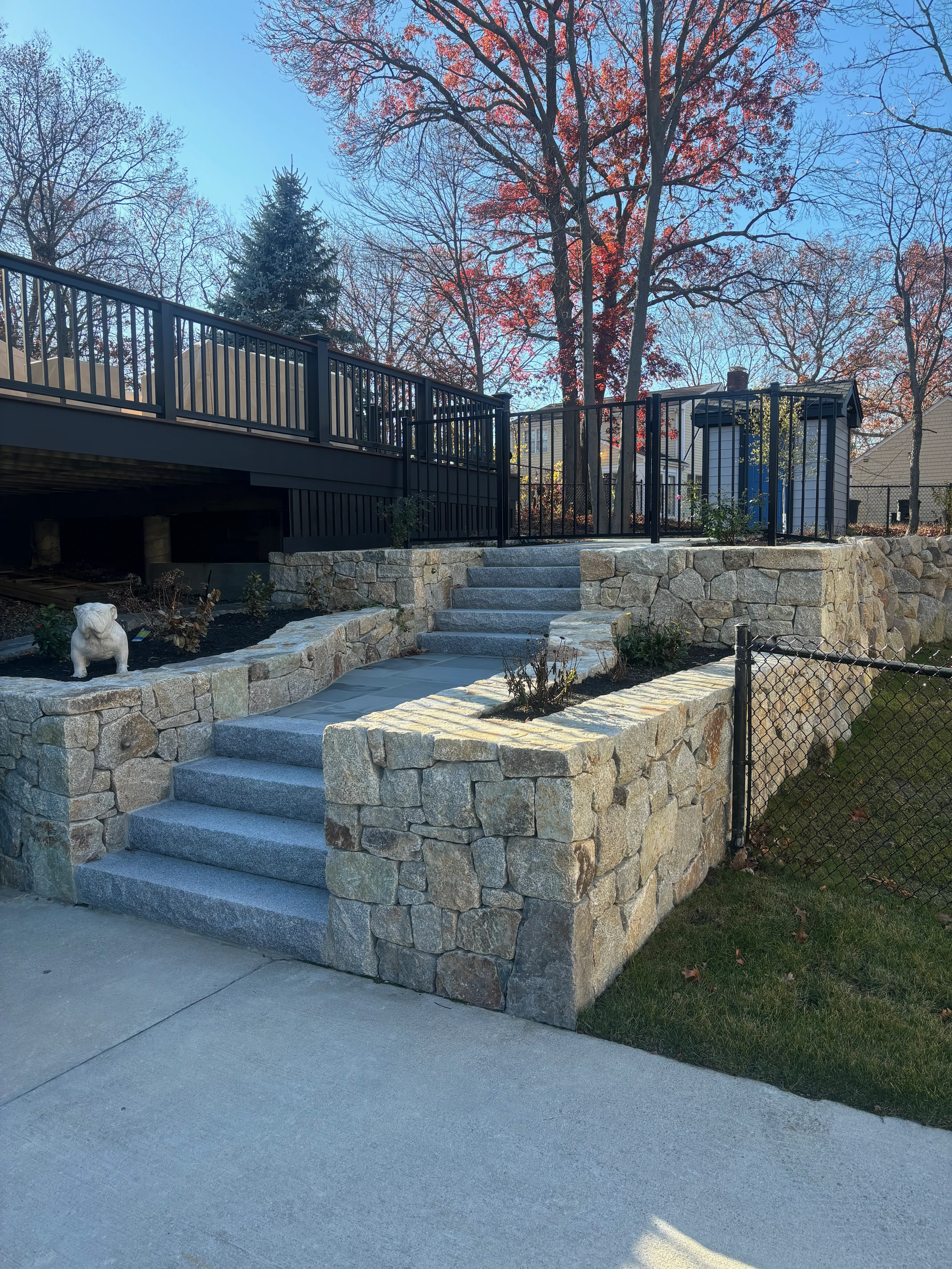 Granite paver patio with curved retaining wall and steps